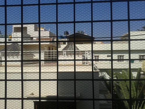 Rodent net installed on apartment balcony to prevent rat entry